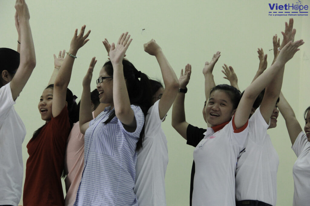 Group of students with hands raised